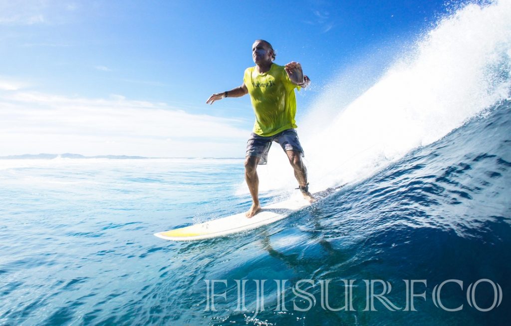 Surfer riding the waves - Courtesy of Fijisurfco