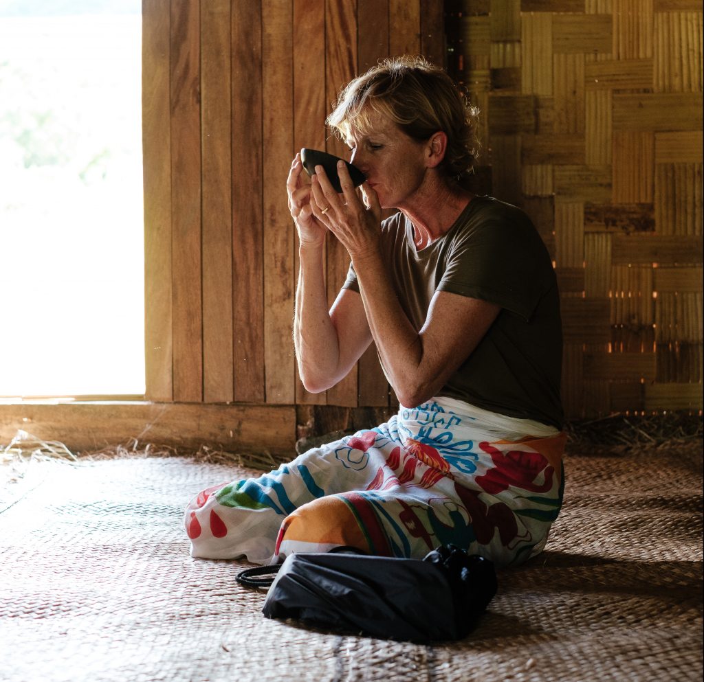 A visitor samples kava in a village