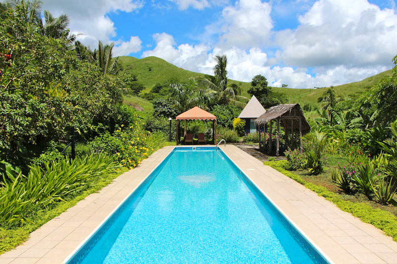 Palmlea Resort Pool is surrounded by a luxurious garden.