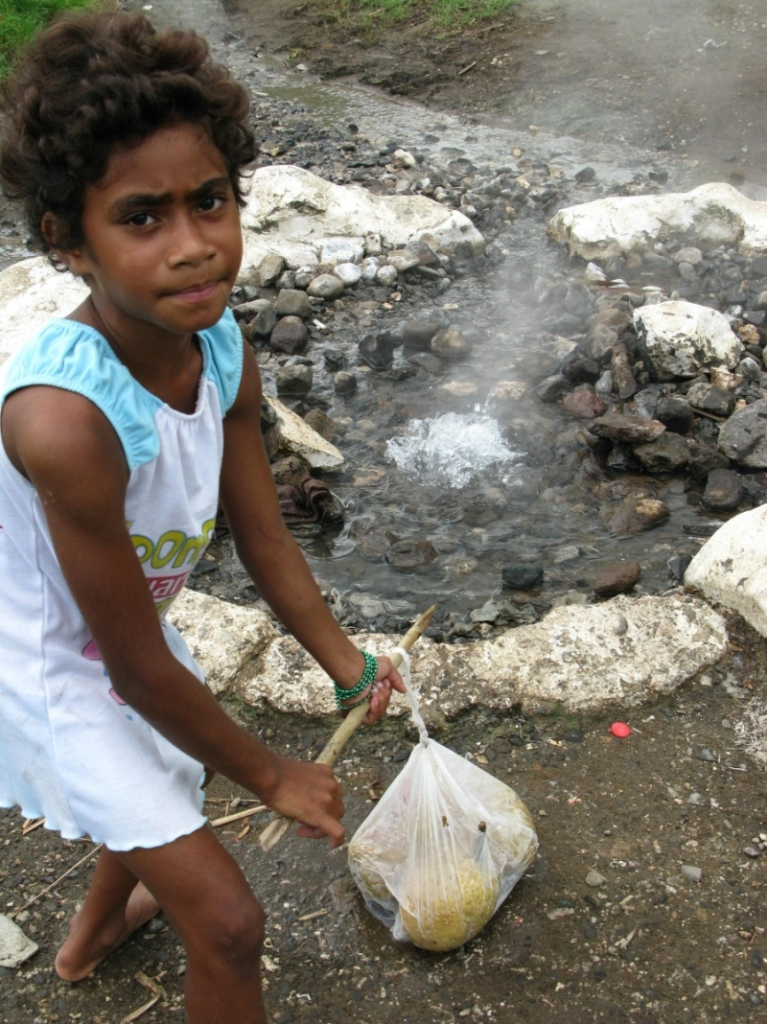 girl is ready to place breadfruit in Nakama hot springs